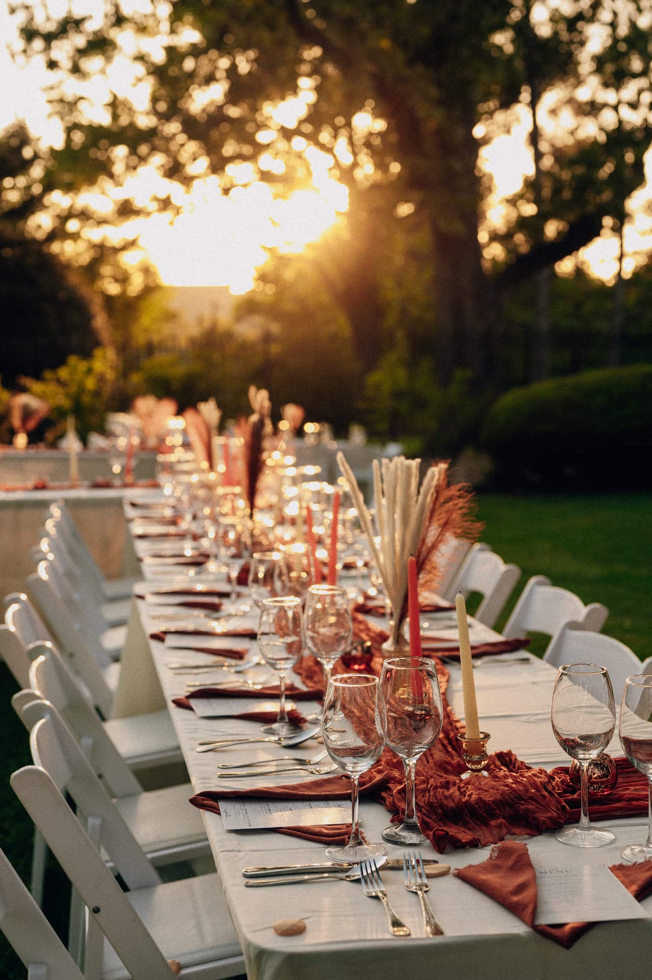 Guests sharing an elegant supper beneath Mississippi oak trees